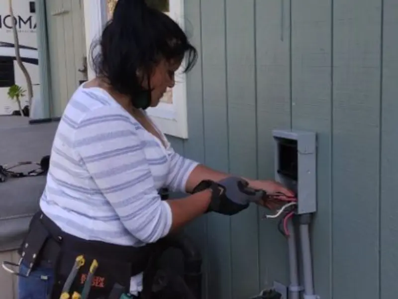 Licensed electrician wiring an exterior subpanel in Mexico